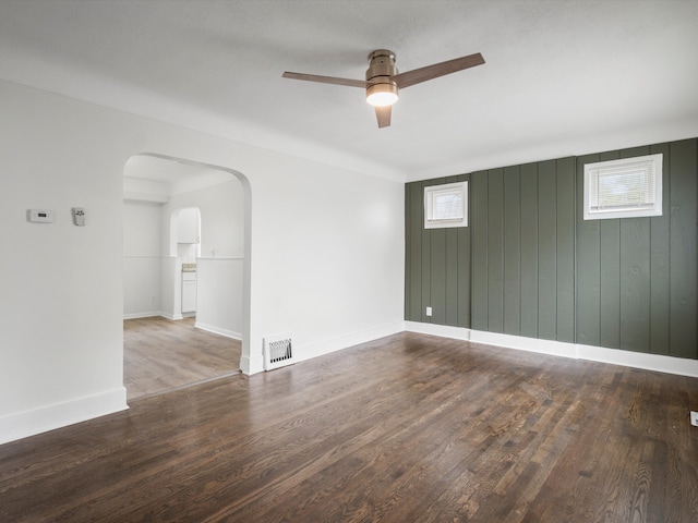 22625 Oaklane St, Warren, MI 48089 - spare room with arched walkways, a ceiling fan, baseboards, wood finished floors, and visible vents
