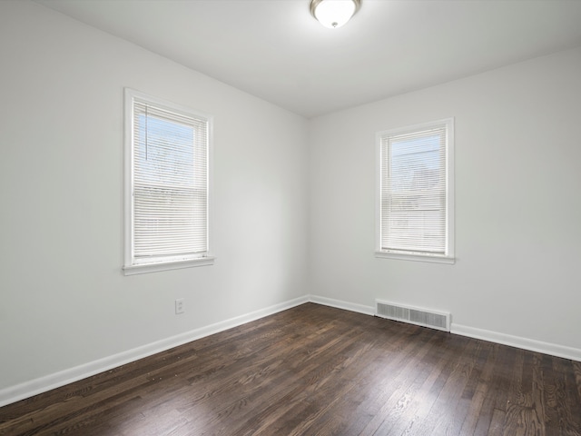 22625 Oaklane St, Warren, MI 48089 - spare room featuring visible vents, dark wood finished floors, and baseboards
