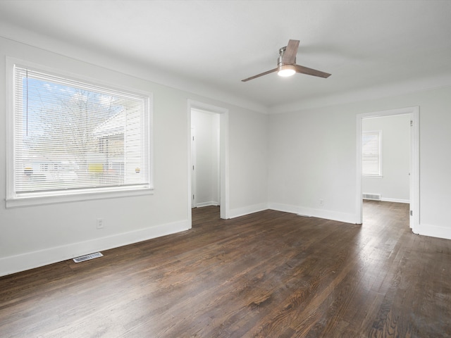 22625 Oaklane St, Warren, MI 48089 - spare room featuring dark wood-style flooring, ceiling fan, visible vents, and baseboards