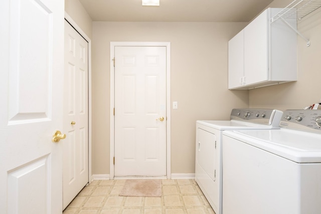 laundry room with baseboards, light floors, cabinet space, and washer and dryer