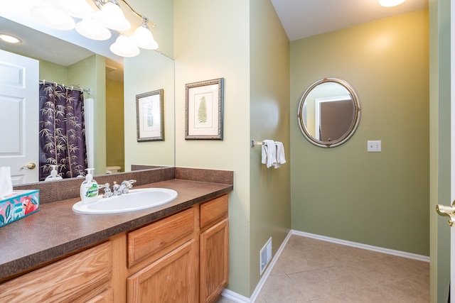 bathroom with baseboards, tile patterned flooring, vanity, and visible vents