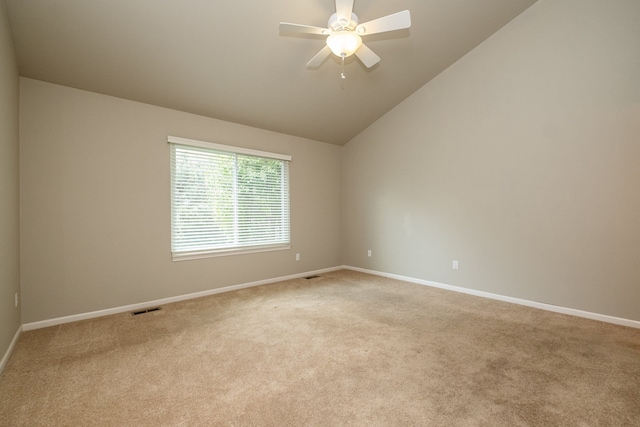 unfurnished room featuring light carpet, a ceiling fan, baseboards, vaulted ceiling, and visible vents