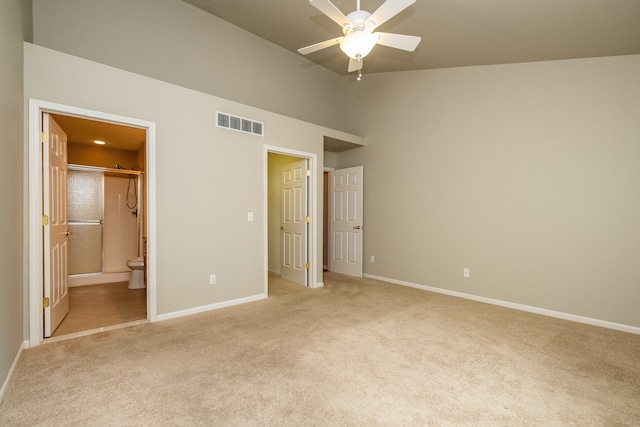 unfurnished bedroom featuring baseboards, ensuite bathroom, light carpet, and visible vents