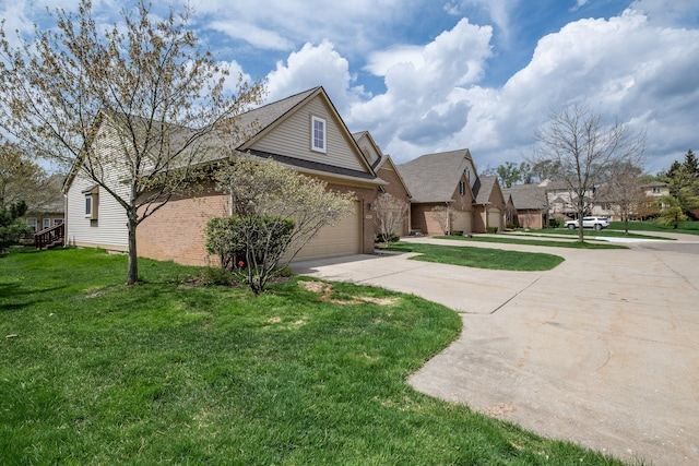 view of front facade featuring an attached garage, concrete driveway, brick siding, and a front yard