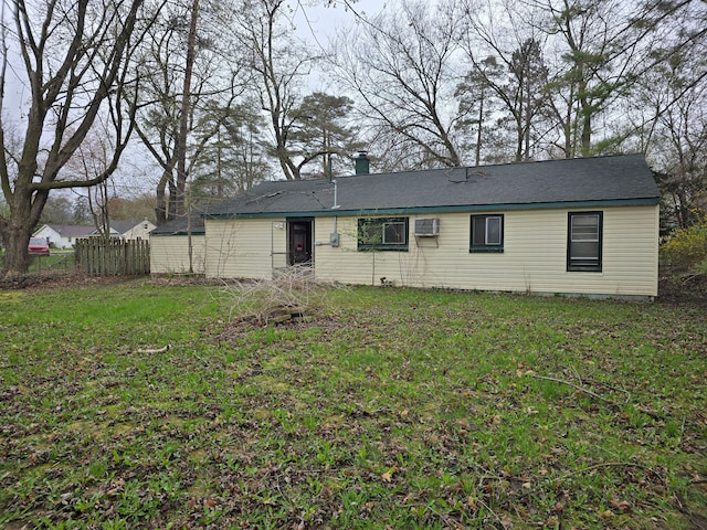 ranch-style home with fence and a front lawn