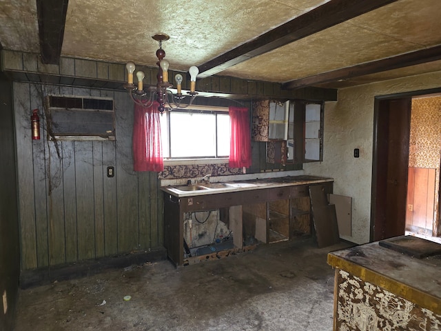 interior space with a sink, wooden walls, and beamed ceiling