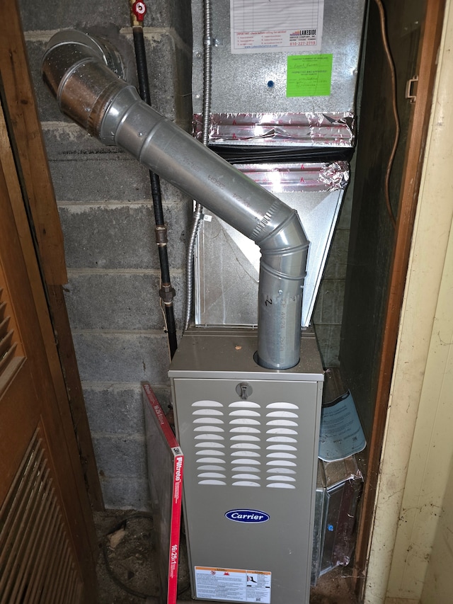 utility room featuring heating unit