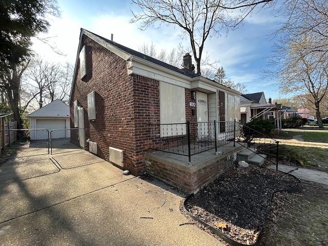17639 Lenore, Detroit, MI 48219 - exterior space featuring a chimney, an outbuilding, a garage, brick siding, and concrete driveway