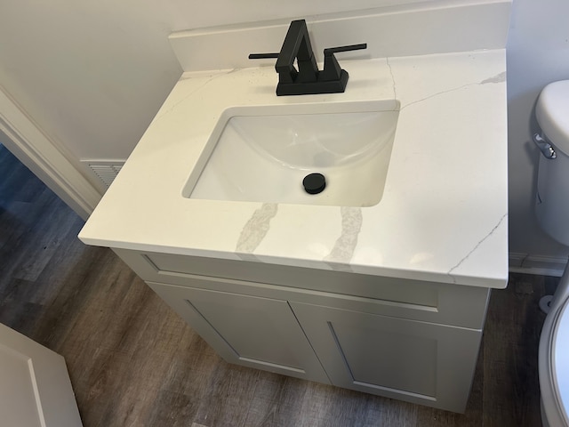 17639 Lenore, Detroit, MI 48219 - interior details featuring vanity, wood finished floors, visible vents, and toilet