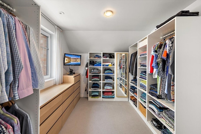 walk in closet featuring lofted ceiling and light carpet