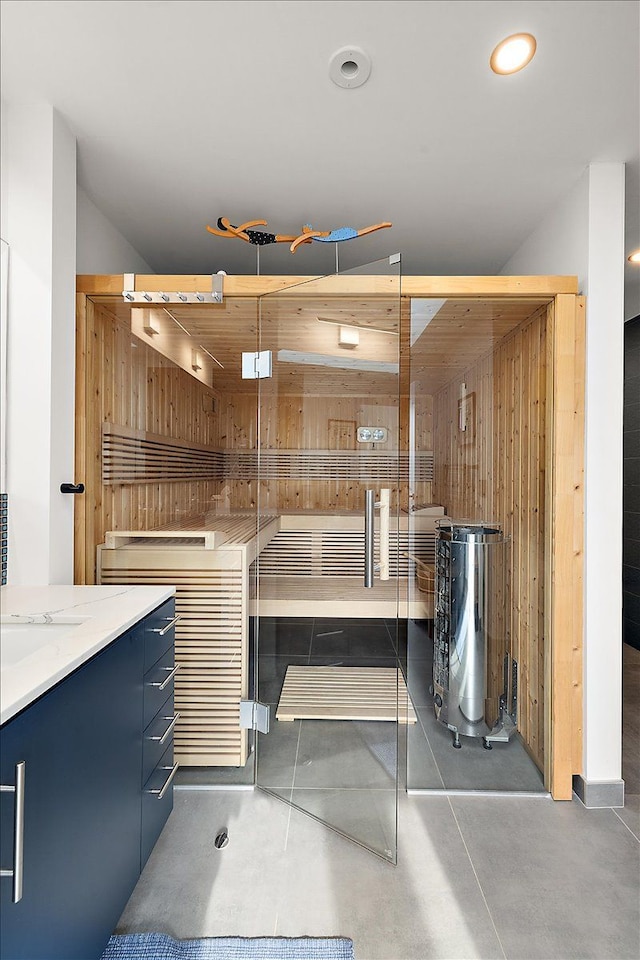 interior space featuring recessed lighting, wood walls, and concrete flooring