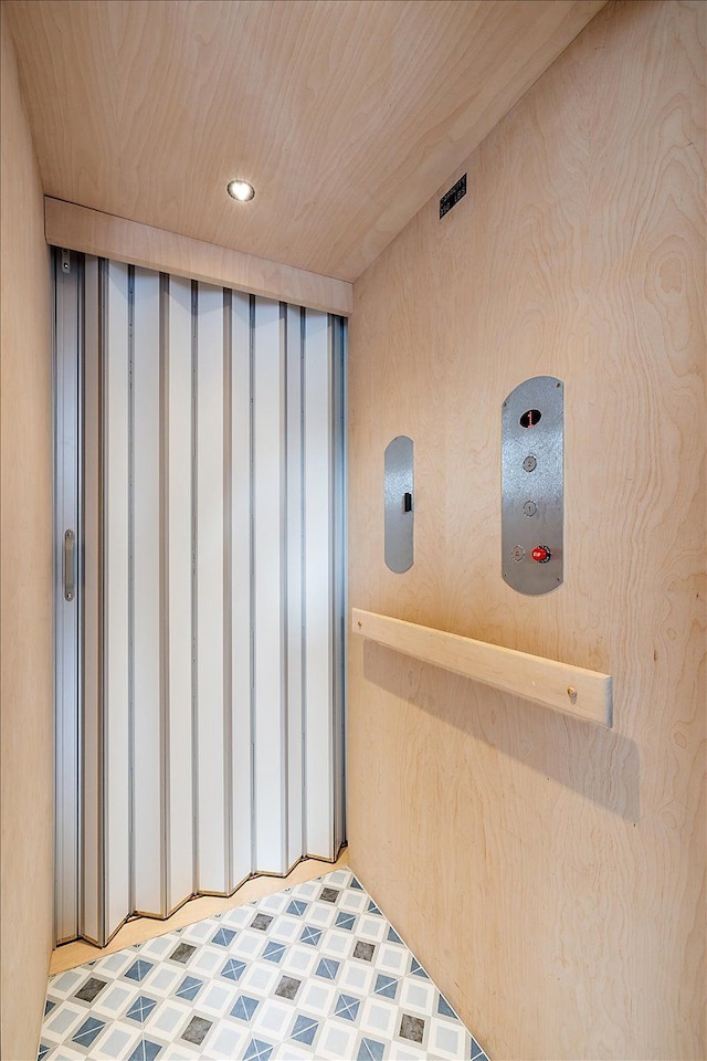interior space featuring recessed lighting, elevator, and tile patterned floors