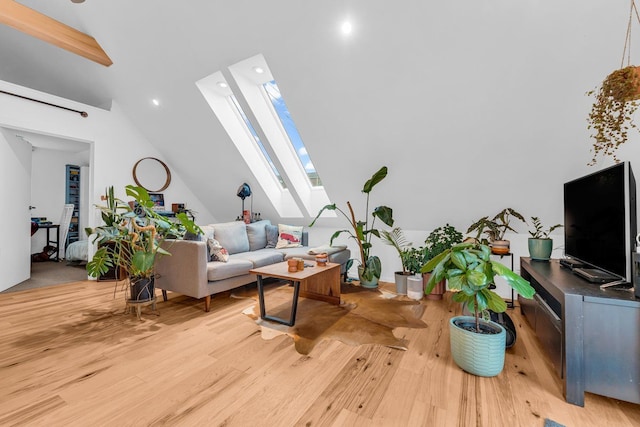 living area with recessed lighting, light wood-type flooring, and lofted ceiling with skylight