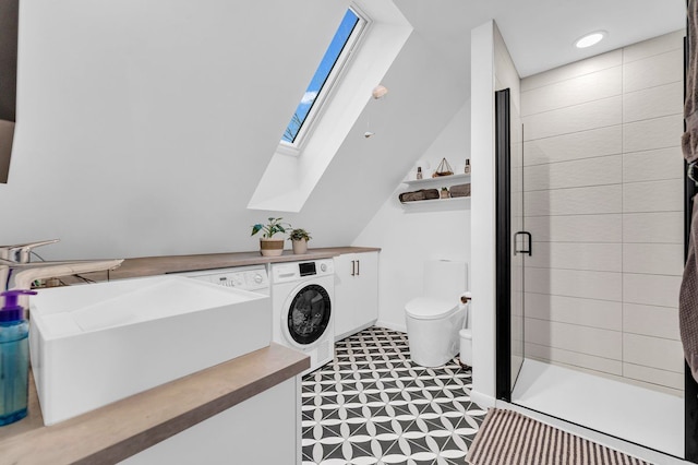 full bath with a sink, a stall shower, toilet, and washer / clothes dryer