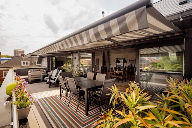 wooden terrace with an outdoor hangout area and outdoor dining space