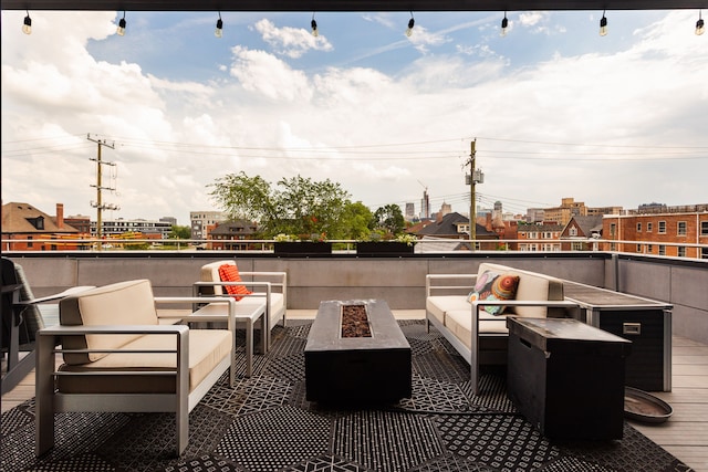 balcony featuring an outdoor living space with a fire pit