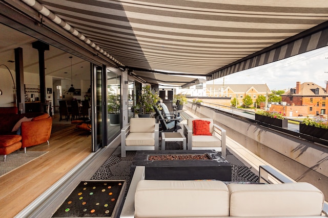 exterior space with a fire pit and a balcony