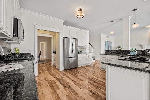 5027 Grover Dr, Brighton, MI 48116 - kitchen with ornamental molding, stainless steel appliances, white cabinetry, and decorative backsplash