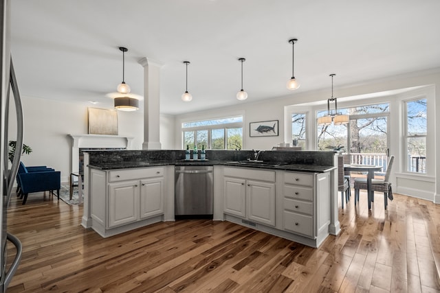 5027 Grover Dr, Brighton, MI 48116 - kitchen with wood-type flooring, a sink, white cabinetry, crown molding, and appliances with stainless steel finishes