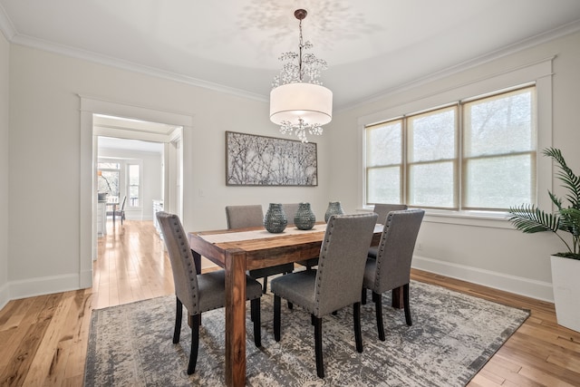 5027 Grover Dr, Brighton, MI 48116 - dining area featuring crown molding, baseboards, an inviting chandelier, and light wood-style floors
