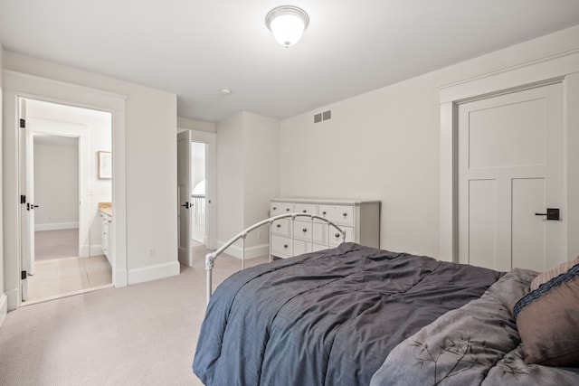 5027 Grover Dr, Brighton, MI 48116 - bedroom with baseboards, ensuite bath, visible vents, and light colored carpet