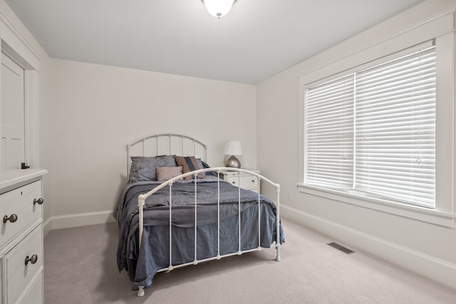 5027 Grover Dr, Brighton, MI 48116 - bedroom featuring baseboards, multiple windows, visible vents, and carpet