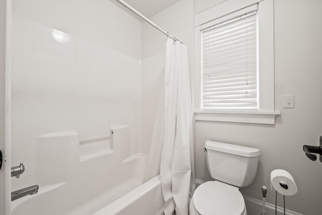 5027 Grover Dr, Brighton, MI 48116 - bathroom with shower / bath combination with curtain, toilet, and baseboards
