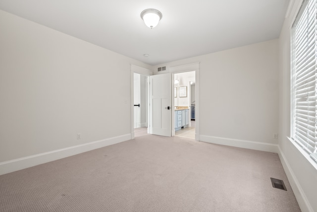 5027 Grover Dr, Brighton, MI 48116 - unfurnished bedroom featuring baseboards, visible vents, and light colored carpet