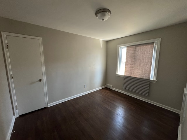 21260 Kipling St, Oak Park, MI 48237 - spare room featuring baseboards, visible vents, and dark wood-type flooring