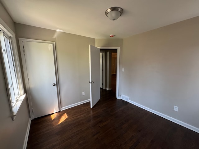 21260 Kipling St, Oak Park, MI 48237 - unfurnished bedroom featuring baseboards, dark wood-type flooring, and visible vents