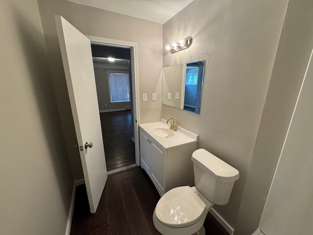 21260 Kipling St, Oak Park, MI 48237 - bathroom featuring toilet, baseboards, wood finished floors, and vanity
