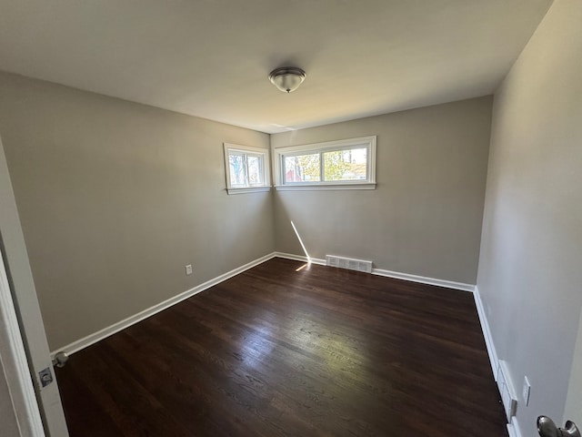 21260 Kipling St, Oak Park, MI 48237 - empty room featuring baseboards, visible vents, and dark wood-type flooring