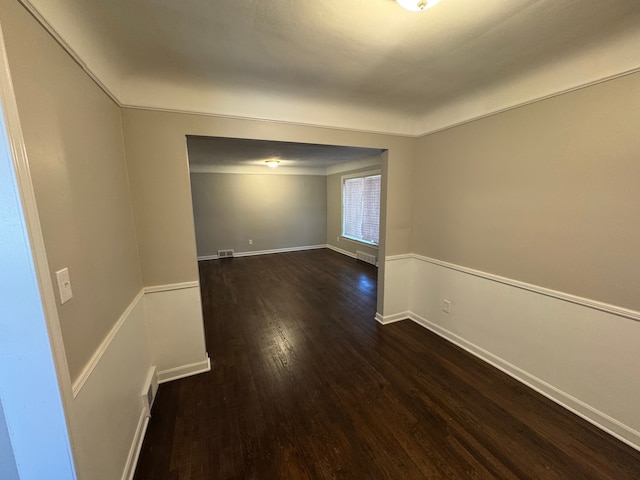 21260 Kipling St, Oak Park, MI 48237 - unfurnished room with baseboards, dark wood-style flooring, and visible vents