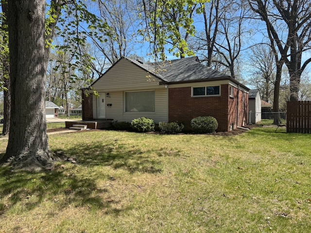 21260 Kipling St, Oak Park, MI 48237 - view of property exterior with a yard, brick siding, and fence
