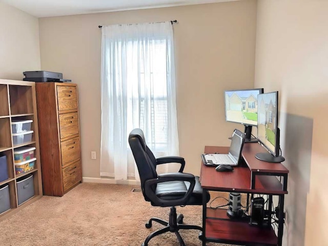 carpeted home office with baseboards