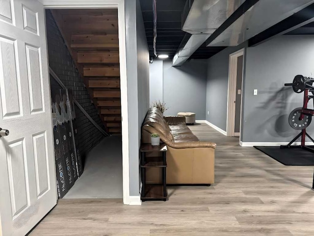 finished basement with baseboards and wood finished floors
