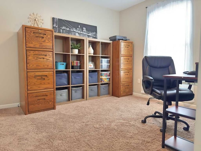 carpeted office featuring baseboards