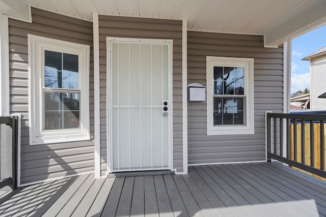 view of exterior entry featuring a deck