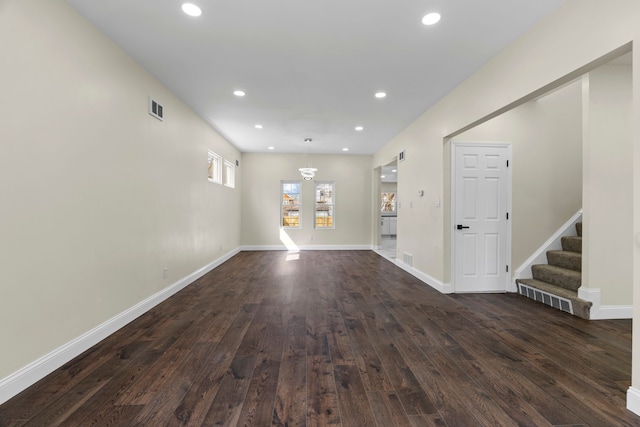 unfurnished living room featuring stairway, recessed lighting, dark wood finished floors, and visible vents