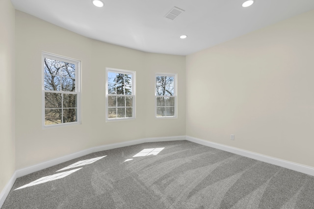 carpeted empty room featuring baseboards, recessed lighting, and visible vents