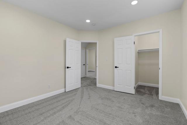 unfurnished bedroom featuring carpet flooring, recessed lighting, and baseboards