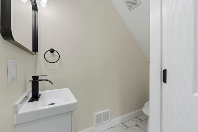 half bathroom featuring toilet, baseboards, visible vents, and marble finish floor