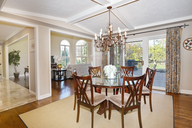dining area featuring baseboards, wood finished floors, a notable chandelier, and vaulted ceiling with beams