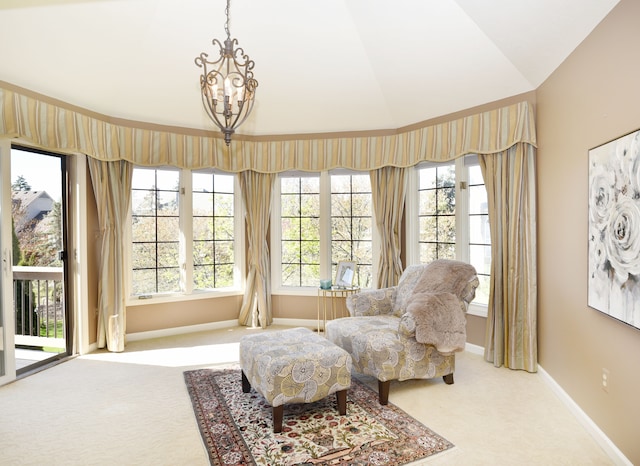 living area with baseboards, light carpet, and lofted ceiling
