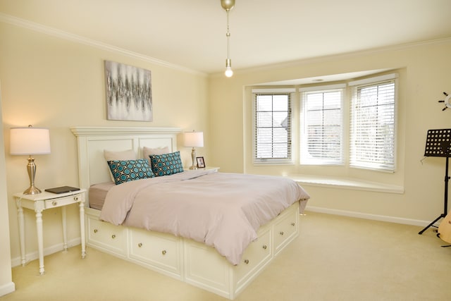carpeted bedroom with baseboards and ornamental molding