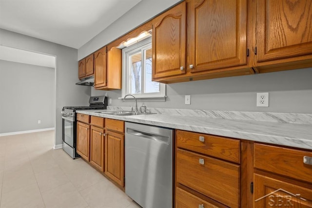 kitchen with a sink, appliances with stainless steel finishes, under cabinet range hood, and brown cabinets