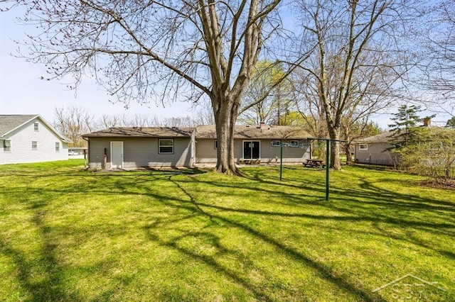 back of house featuring a yard