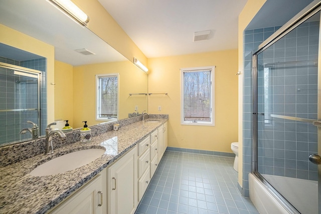 bathroom with tile patterned floors, a wealth of natural light, and a sink