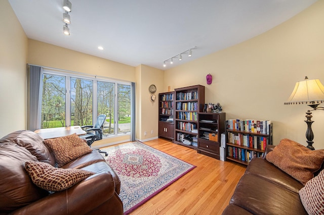 living room featuring track lighting and wood finished floors