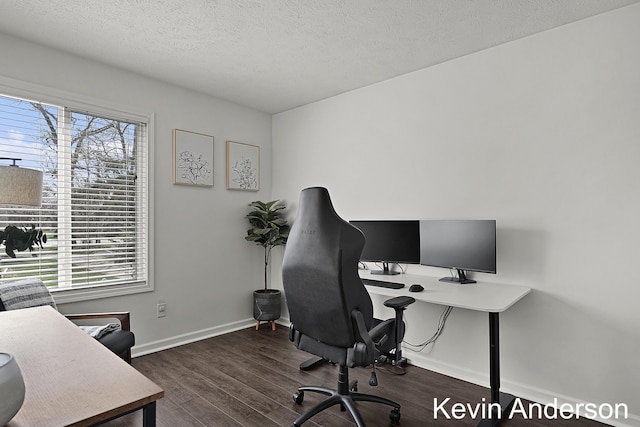 office area with baseboards, dark wood finished floors, and a textured ceiling